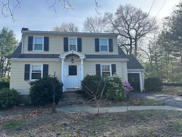 283 Woodland Rd, Newton, MA 02466 - view of front facade with driveway and a chimney