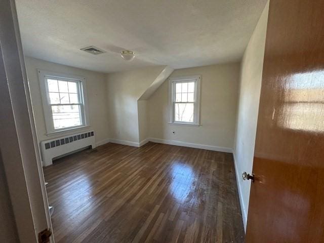 283 Woodland Rd, Newton, MA 02466 - bonus room with radiator, baseboards, wood finished floors, and visible vents