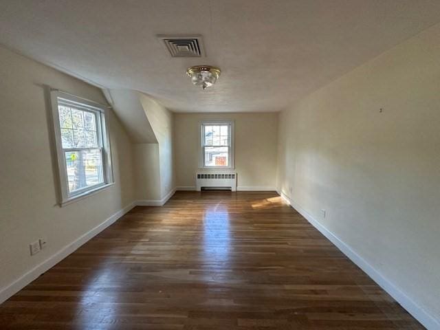 283 Woodland Rd, Newton, MA 02466 - additional living space with baseboards, visible vents, radiator heating unit, and wood finished floors