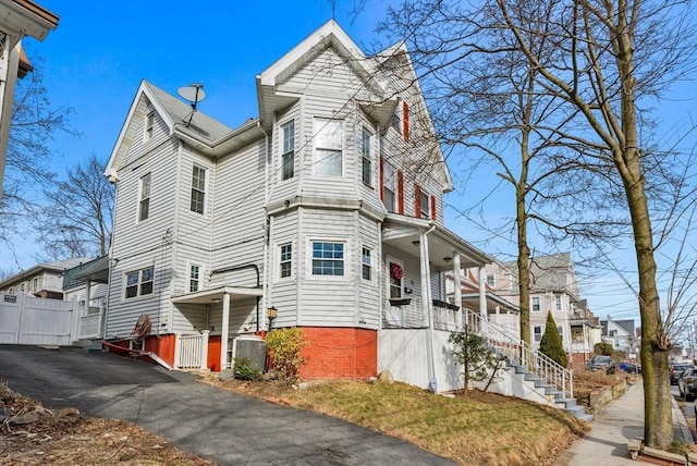 18 Newhall St, Malden, MA 02148 - view of property exterior featuring covered porch, stairway, and a residential view