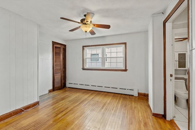 18 Newhall St, Malden, MA 02148 - unfurnished bedroom with a baseboard heating unit, light wood-style floors, a closet, and ceiling fan