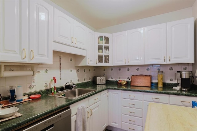kitchen with stainless steel dishwasher, white cabinetry, and tasteful backsplash