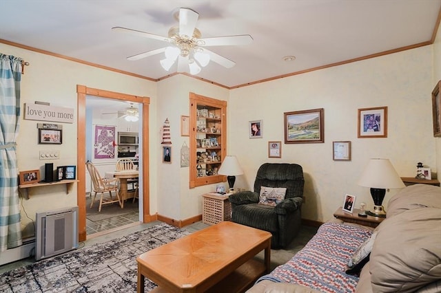 living area with ceiling fan, ornamental molding, and baseboards