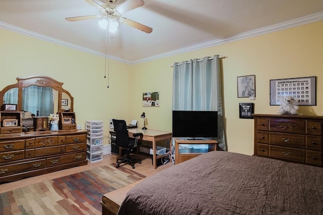 bedroom featuring ornamental molding, wood finished floors, ceiling fan, and a desk