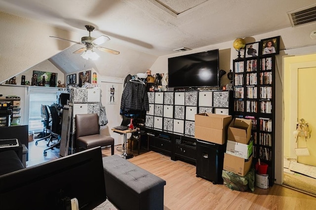 office with wood finished floors, a ceiling fan, vaulted ceiling, and a textured ceiling