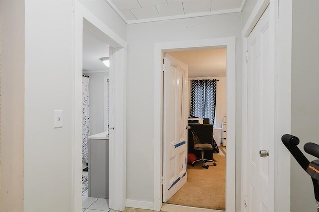 hall featuring an office area and baseboards