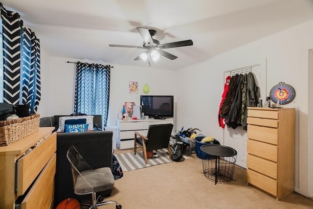 home office featuring light colored carpet and ceiling fan