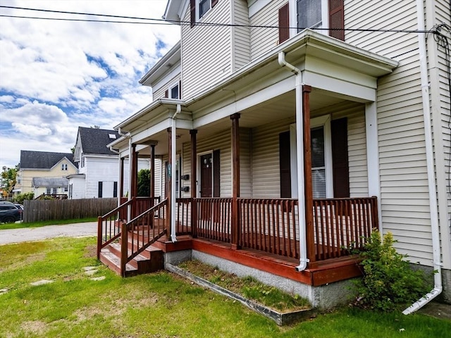 view of exterior entry featuring a porch