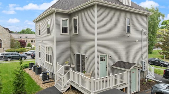 25 Conant St Unit 1, Danvers, MA 01923 - rear view of house featuring cooling unit, a lawn, and roof with shingles