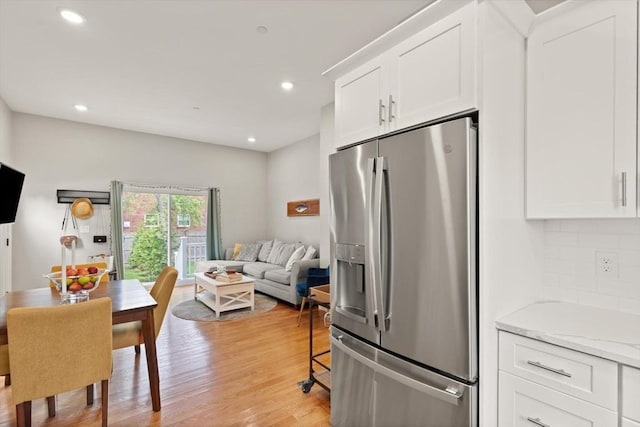25 Conant St Unit 1, Danvers, MA 01923 - kitchen featuring stainless steel fridge, white cabinetry, light wood finished floors, decorative backsplash, and recessed lighting