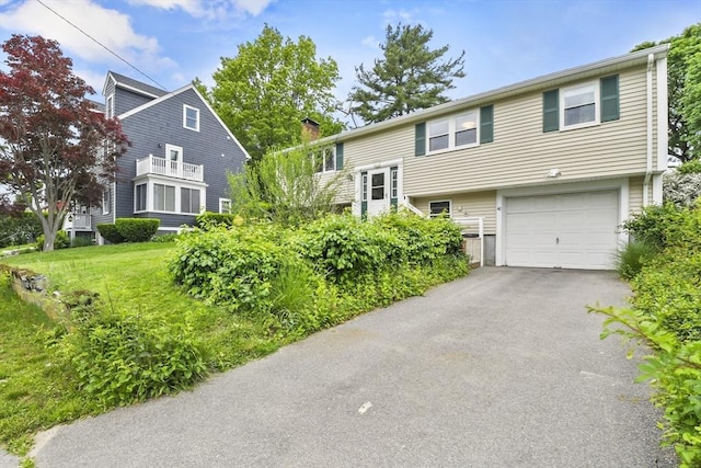 40 Winslow Rd, Quincy, MA 02171 - view of front facade with a garage, a chimney, and asphalt driveway