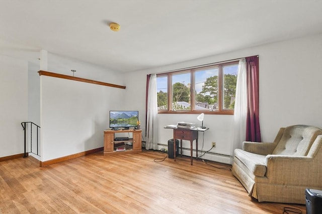40 Winslow Rd, Quincy, MA 02171 - living area with a baseboard heating unit and light wood-style flooring