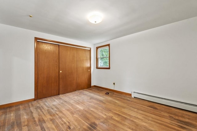 40 Winslow Rd, Quincy, MA 02171 - unfurnished bedroom with a baseboard radiator, wood finished floors, and a closet