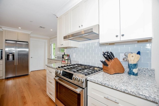 324 Front St Unit 4, Marion, MA 02738 - kitchen with stainless steel appliances, under cabinet range hood, ornamental molding, backsplash, and light wood-style floors
