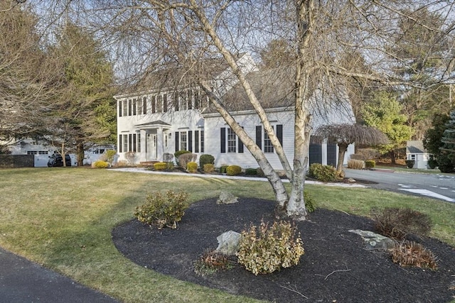 colonial-style house with a front yard