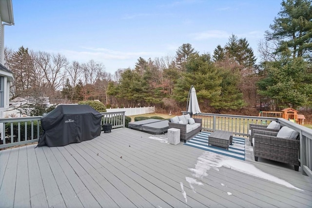 wooden terrace with a grill and an outdoor hangout area