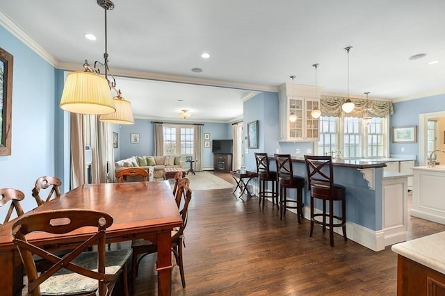 dining area with crown molding, dark wood-style flooring, and recessed lighting