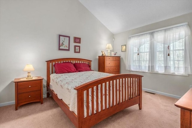carpeted bedroom featuring baseboards, visible vents, and vaulted ceiling