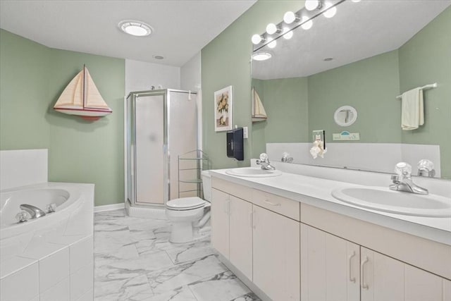 bathroom with a garden tub, a shower stall, marble finish floor, and a sink