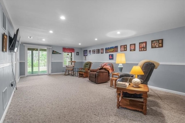 carpeted living room featuring visible vents, recessed lighting, and baseboards