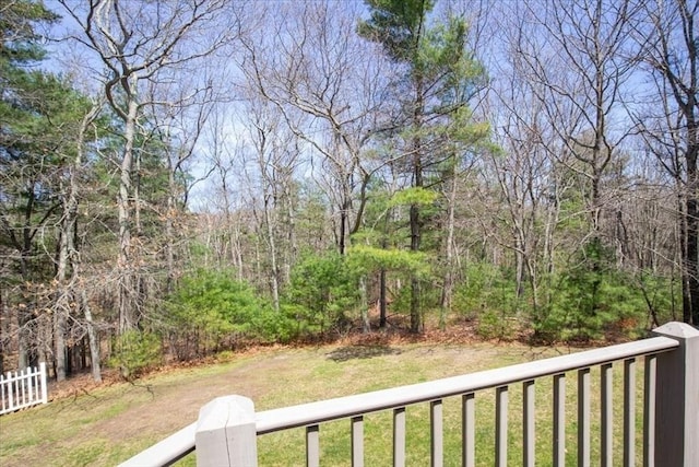 view of yard featuring a forest view and fence