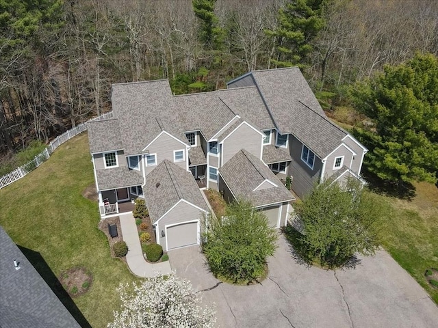 birds eye view of property featuring a wooded view