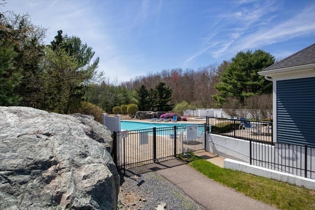 community pool featuring a patio area and fence
