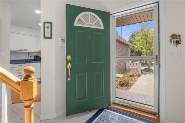 entrance foyer with baseboards and light tile patterned flooring