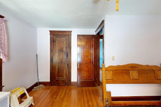 bedroom with light wood-style flooring and baseboards