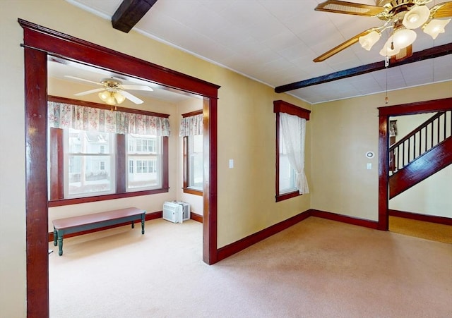 empty room with light colored carpet, ceiling fan, and baseboards