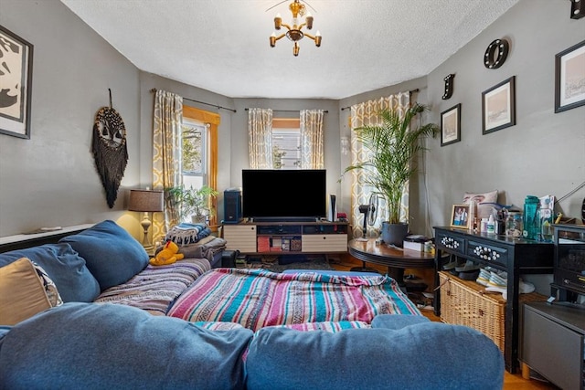 living room featuring a textured ceiling and a chandelier