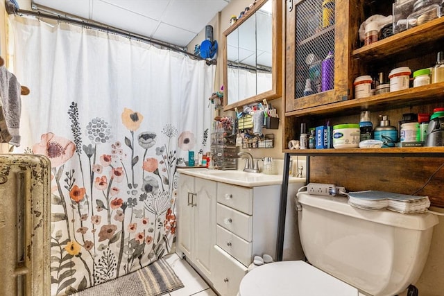 bathroom with tile patterned flooring, a shower with curtain, toilet, and vanity