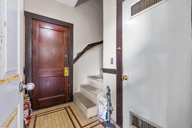 entryway featuring light tile patterned flooring and stairway