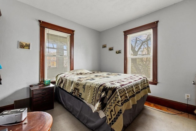 bedroom featuring carpet floors and baseboards