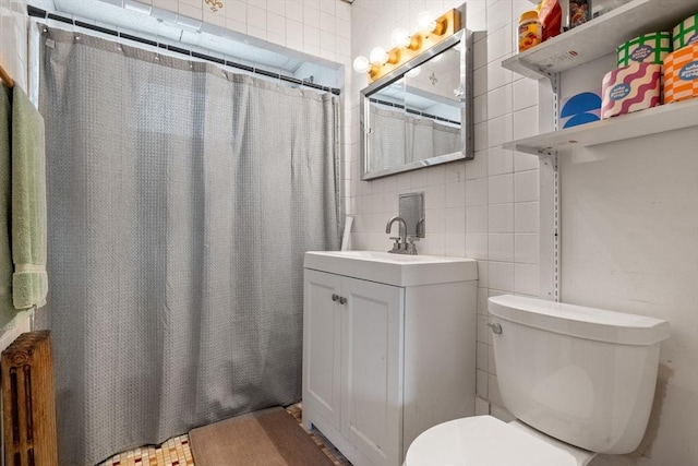 full bathroom featuring vanity, curtained shower, toilet, and tile walls