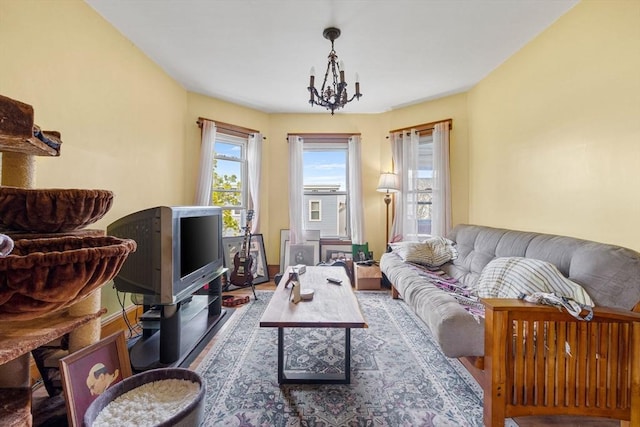 living room featuring wood finished floors and a notable chandelier
