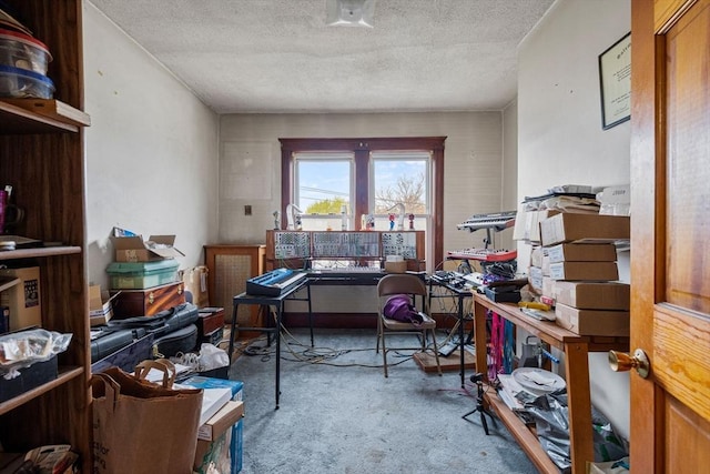 carpeted office featuring a textured ceiling