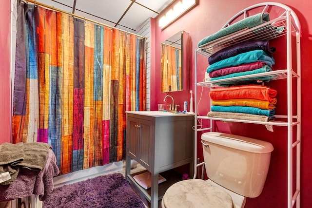 bathroom featuring vanity, toilet, and a shower with shower curtain
