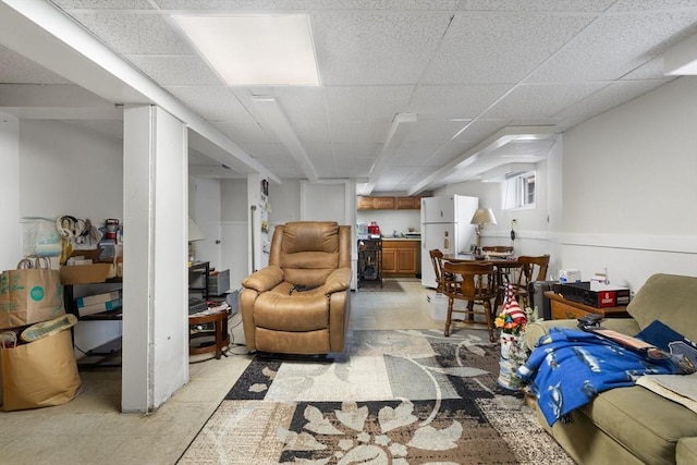living area featuring a paneled ceiling