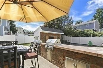 6 Yellow Brick Rd, Haverhill, MA 01835 - view of patio with outdoor dining area, a fenced backyard, an outdoor kitchen, and grilling area
