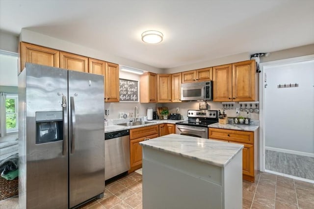 30 Taylor St Unit 1, Haverhill, MA 01832 - kitchen with stainless steel appliances, a sink, light stone counters, and a kitchen island
