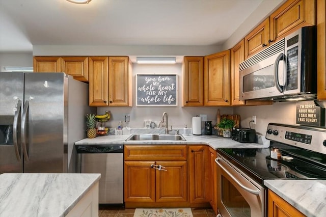 30 Taylor St Unit 1, Haverhill, MA 01832 - kitchen featuring stainless steel appliances, a sink, brown cabinetry, and light tile patterned floors