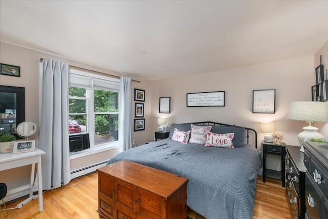 30 Taylor St Unit 1, Haverhill, MA 01832 - bedroom featuring a baseboard heating unit, light wood-style floors, and cooling unit