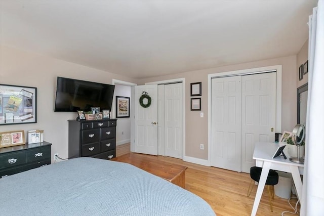 30 Taylor St Unit 1, Haverhill, MA 01832 - bedroom featuring two closets, light wood-type flooring, and baseboards