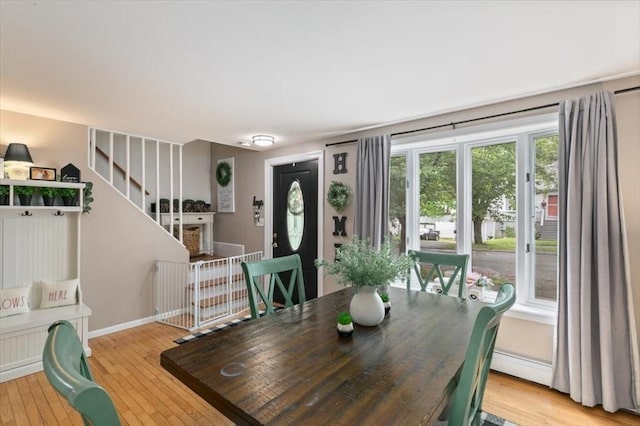 30 Taylor St Unit 1, Haverhill, MA 01832 - dining room featuring light wood-style flooring, baseboards, stairway, and a baseboard heating unit