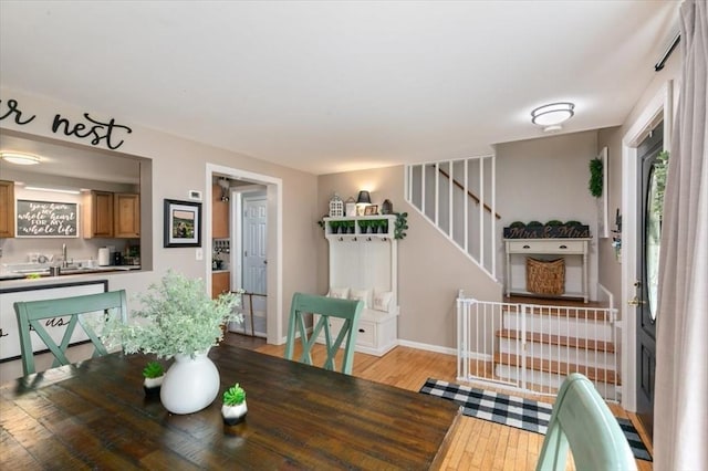 30 Taylor St Unit 1, Haverhill, MA 01832 - dining space featuring light wood finished floors, stairs, and baseboards