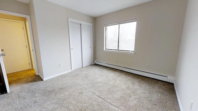 10 Williams Unit 39, Watertown, MA 02472 - unfurnished bedroom with baseboard heating, carpet, a closet, and baseboards
