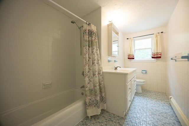 286 Mountain St, Sharon, MA 02067 - full bath featuring shower / bathtub combination with curtain, vanity, tile walls, baseboard heating, and wainscoting