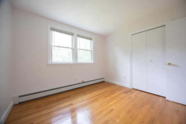 286 Mountain St, Sharon, MA 02067 - unfurnished bedroom featuring a baseboard radiator, light wood finished floors, and a closet