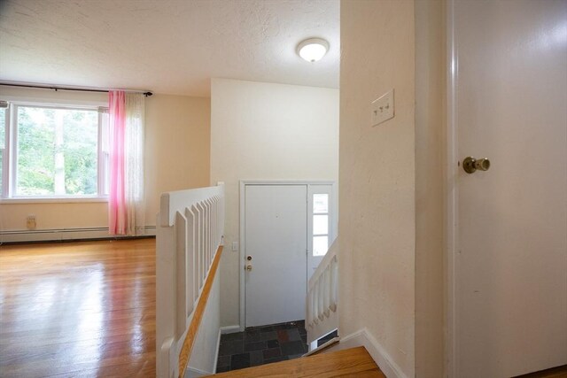 286 Mountain St, Sharon, MA 02067 - entryway featuring healthy amount of natural light, a textured ceiling, and a baseboard heating unit